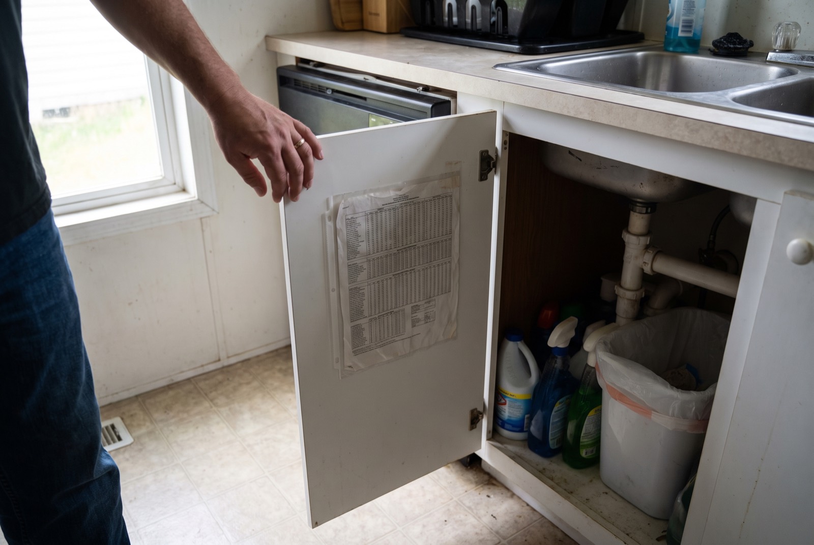 A cabinet door held open to show the data plate sheet fixed inside it